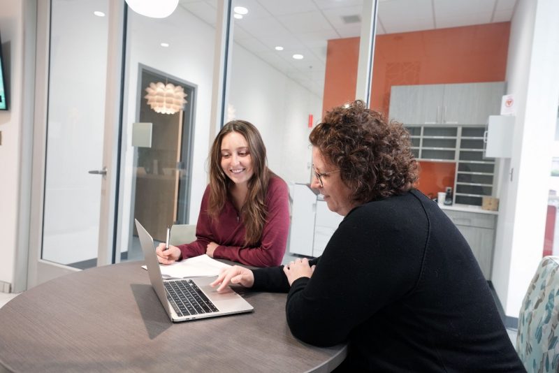 Director Kelly Scarff (right) works with a student.